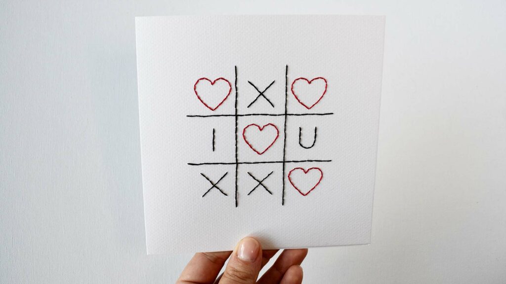 Hand embroidered paper card with Love Tic Tac Toe design
